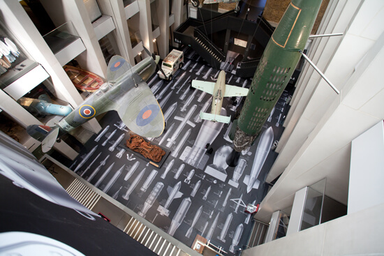 Top view of the IWM London's atrium, where Ai Weiwei's "History of Bombs" is on display using printed Harlequin Clarity vinyl floor