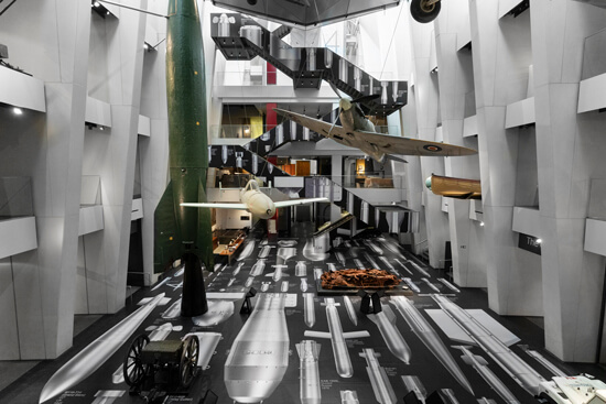 Full view of the IWM London's atrium, where Ai Weiwei's "History of Bombs" is on display using printed Harlequin Clarity vinyl floor