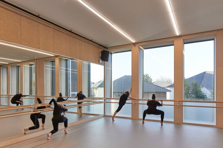 Students dancing and stretching on Harlequin floors at Kingston University