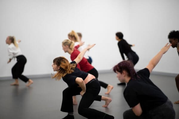 Students in the middle of a fast dance rehearsal