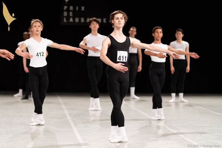 Male contestants perform ballet