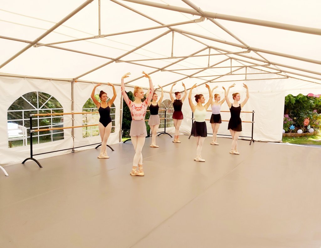 Ballerinas taking a dance class on Harlequin outdoor floor